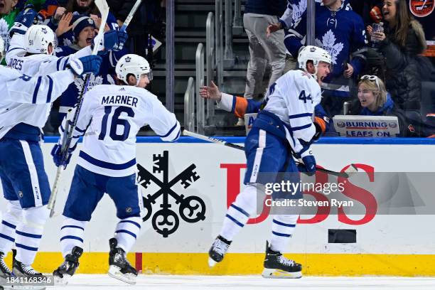 Morgan Rielly of the Toronto Maple Leafs celebrates after scoring a goal against the New York Islanders during the third period at UBS Arena on...