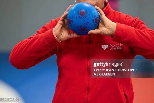 Person wearing a jacket « French federation of cardiology » takes part in an adapted gym session set up by the Meurthe-et-Moselle French Federation...