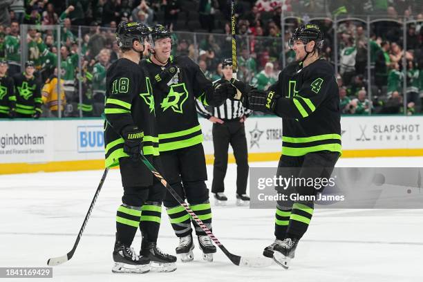 Miro Heiskanen, Sam Steel, and Ryan Suter of the Dallas Stars celebrate a goal against the Detroit Red Wings at the American Airlines Center on...