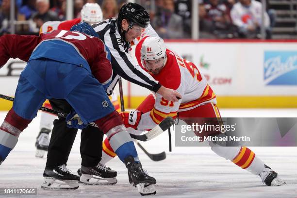 Ryan Johansen of the Colorado Avalanche faces off against Nazem Kadri of the Calgary Flames at Ball Arena on December 11, 2023 in Denver, Colorado.