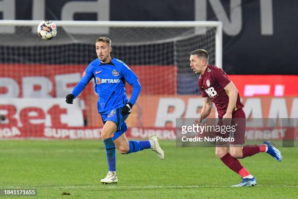 Mihai Lixandru and Lovro Cvek are in action during the match between CFR Cluj and FCSB at Dr. Constantin Radulescu Stadium in Cluj-Napoca, Romania,...