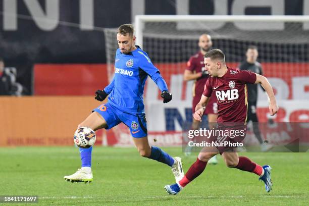 Mihai Lixandru and Lovro Cvek are in action during the match between CFR Cluj and FCSB at Dr. Constantin Radulescu Stadium in Cluj-Napoca, Romania,...