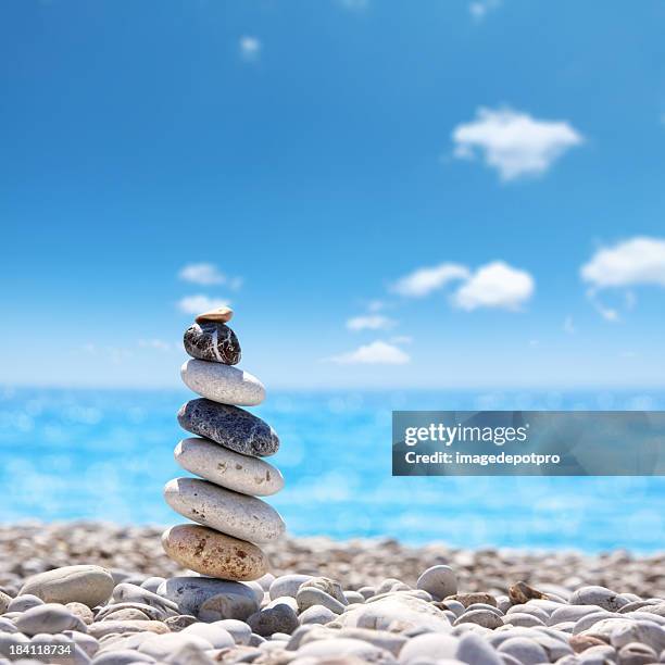 stone balance on beach - aura stock pictures, royalty-free photos & images