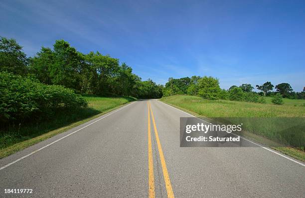 road through sunny countryside - open highway stock pictures, royalty-free photos & images