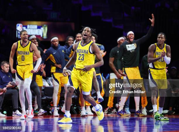 The Indiana Pacers bench reacts after Aaron Nesmith scored and drew a foul against the Milwaukee Bucks in the second half of the East semifinal game...