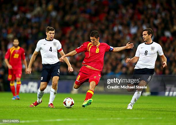 Stevan Jovetic of Montenegro shoots as Steven Gerrard and Frank Lampard of England during the FIFA 2014 World Cup Qualifying Group H match between...