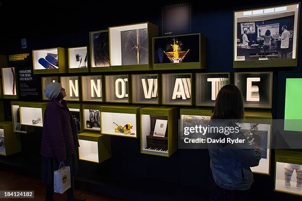 Visitors explore installations during a launch event for the Bezos Center for Innovation at the Museum of History and Industry on October 11, 2013 in...
