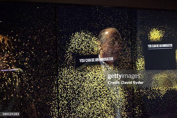 Christopher Ozubko interacts with an installation during a launch event for the Bezos Center for Innovation at the Museum of History and Industry on...