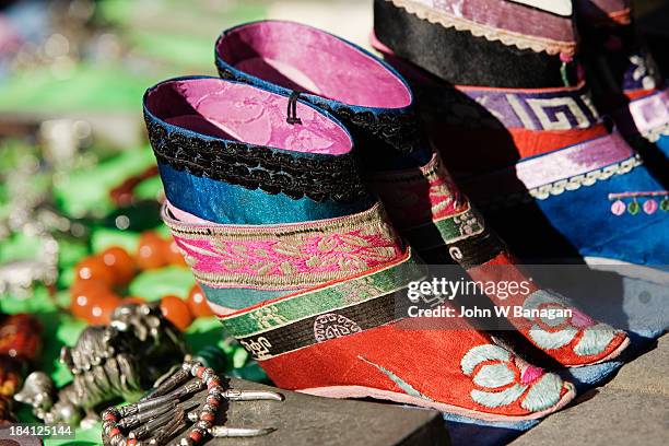 tiny shoes for womens bound feet - foot binding stock pictures, royalty-free photos & images
