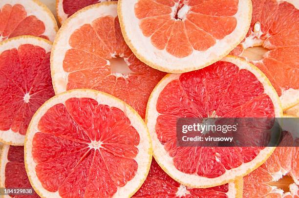 fresh grapefruit and slices - grapefruit stockfoto's en -beelden