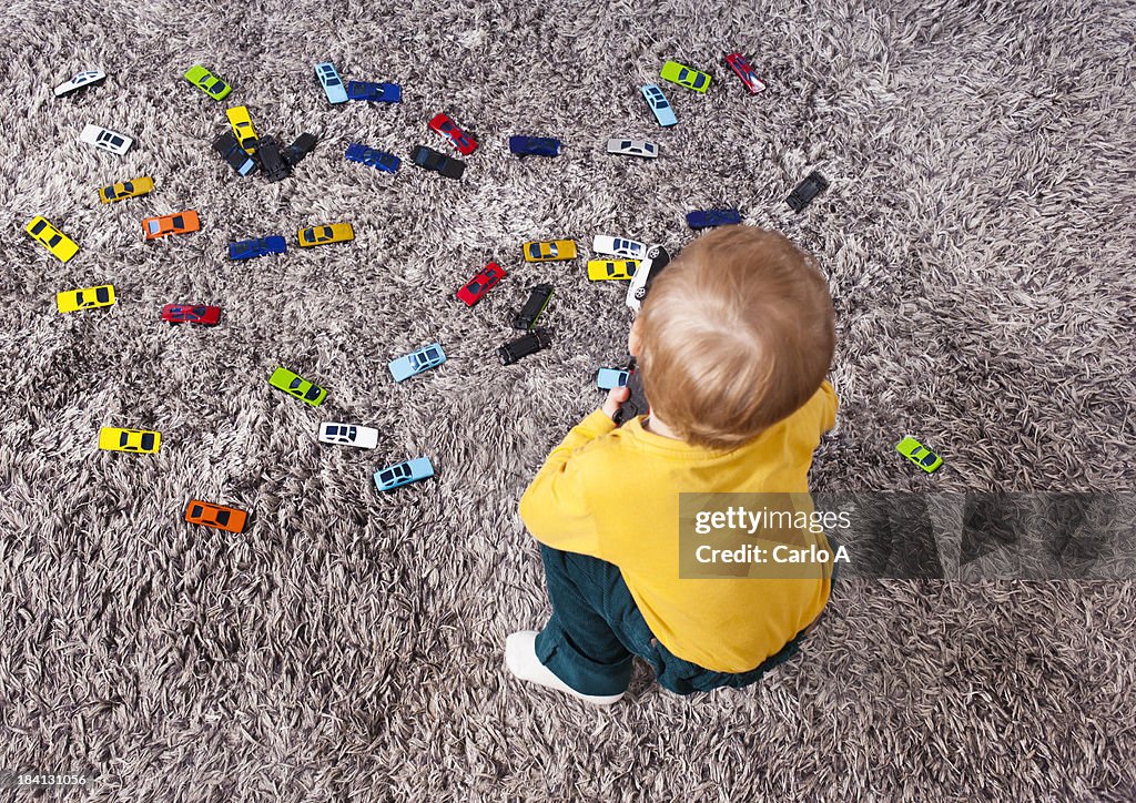 Baby boy with car toys