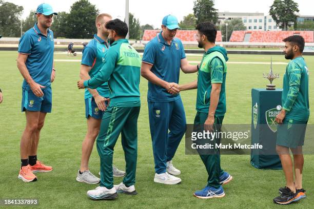 Players shake hands after the match is drawn during day four of the Tour match between PMs XI and Pakistan at Manuka Oval on December 09, 2023 in...