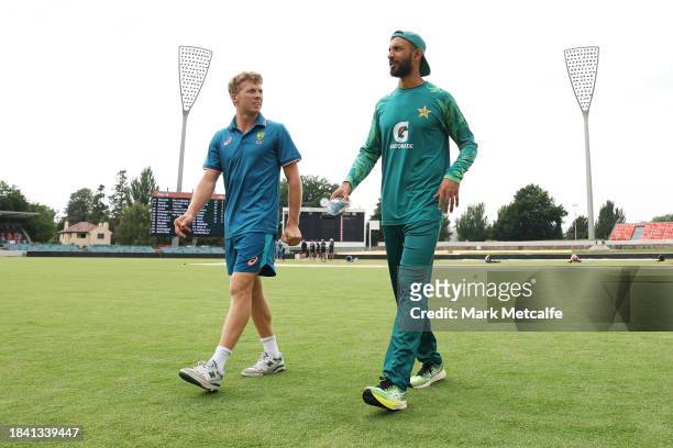 Captains Nathan McSweeney of the Prime Ministers XI and Shan Masood of Pakistan walk from the field of play after the match is drawn during day four...