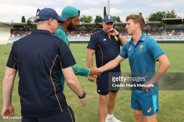 Captains Nathan McSweeney of the Prime Ministers XI and Shan Masood of Pakistan shake hands after the match is drawn during day four of the Tour...