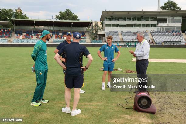 Captains Nathan McSweeney of the Prime Ministers XI and Shan Masood of Pakistan inspect the pitch before the match is drawn during day four of the...