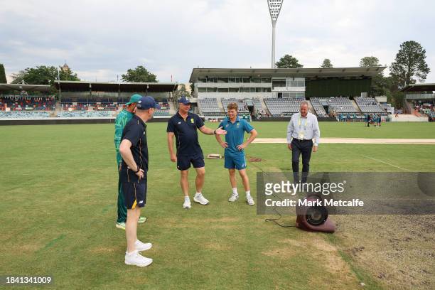 Captains Nathan McSweeney of the Prime Ministers XI and Shan Masood of Pakistan inspect the pitch before the match is drawn during day four of the...