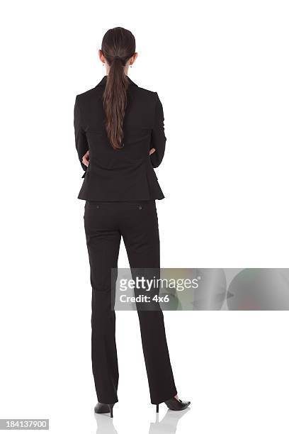 rear view of businesswoman standing with arms crossed - woman full body behind stock pictures, royalty-free photos & images