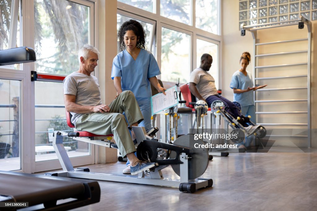 Physical therapists helping patients at a rehabilitation center