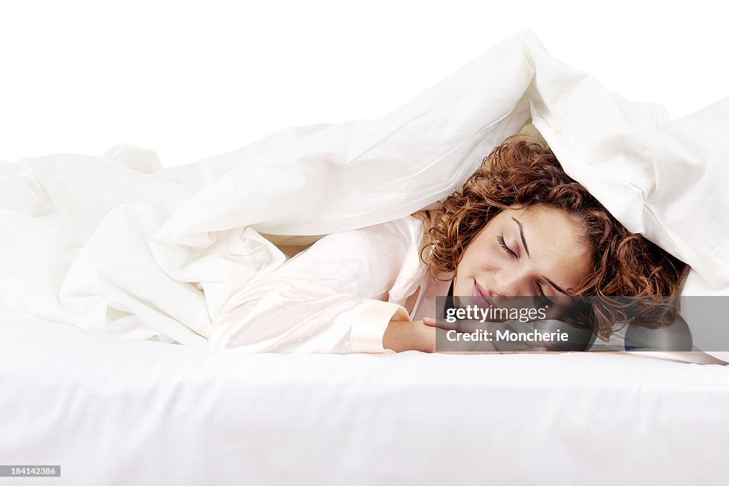 Beautiful young woman sleeping in bed