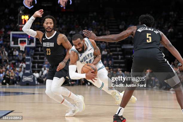 Mike Conley of the Minnesota Timberwolves drives to the basket against Derrick Rose of the Memphis Grizzlies during the first half at FedExForum on...