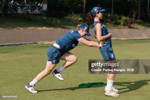 Maia Bouchier and Heather Knight of England warm up during a net session at DY Patil Stadium on December 12, 2023 in Navi Mumbai, India.