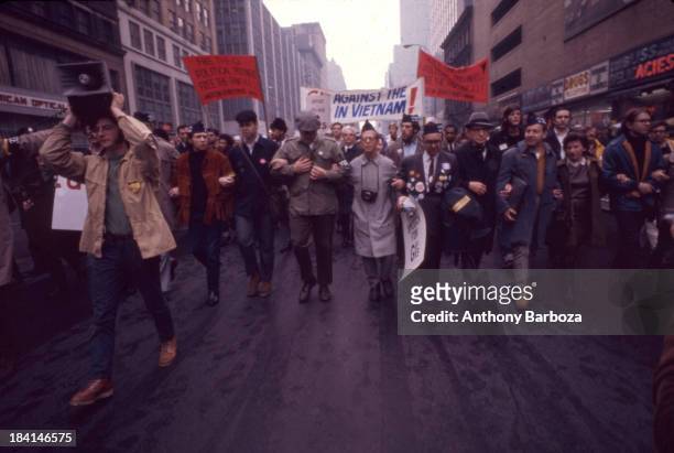 View of a demonstrators, including several veterans, as the march along a street during a protest against the Vietnam War, New York, New York, 1968.