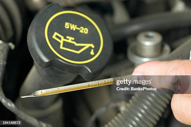 male finger checking oil level on a dipstick - dipstick stock pictures, royalty-free photos & images