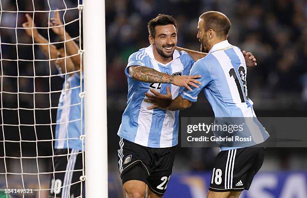 Ezequiel Lavezzi and Rodrigo Palacio celebrate a goal during a match between Argentina and Peru as part of the 17th round of the South American...