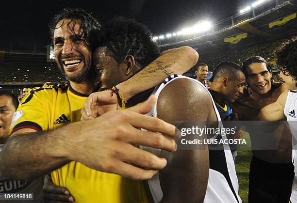 Colombia's defender Mario Yepes and midfielder Carlos Sanchez celebrate after qualifying for the Brazil 2014 FIFA World Cup after a 3-3 tie with...