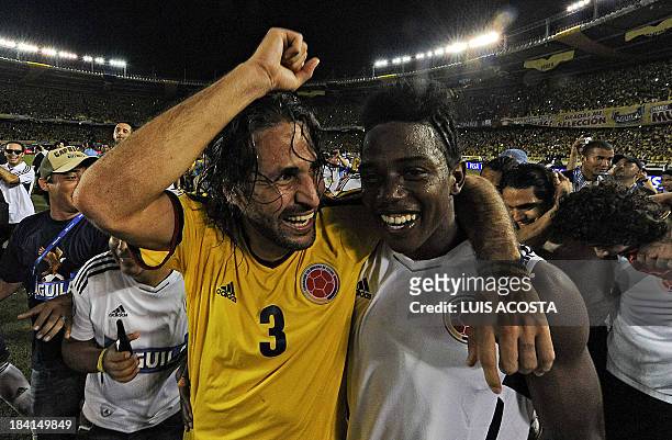 Colombia's defender Mario Yepes and midfielder Carlos Sanchez celebrate after qualifying for the Brazil 2014 FIFA World Cup after a 3-3 tie with...