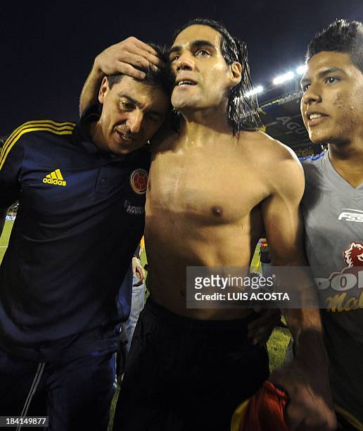 Colombia's forward Radamel Falcao and the trainer of Colombia's football goalkeepers, Eduardo Niño, celebrate after qualifying for the Brazil 2014...
