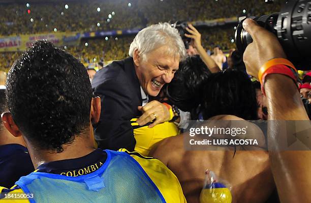 Colombia's coach Jose Pekerman and members of the team celebrates after qualifying for the Brazil 2014 FIFA World Cup after a 3-3 tie with Chile in a...