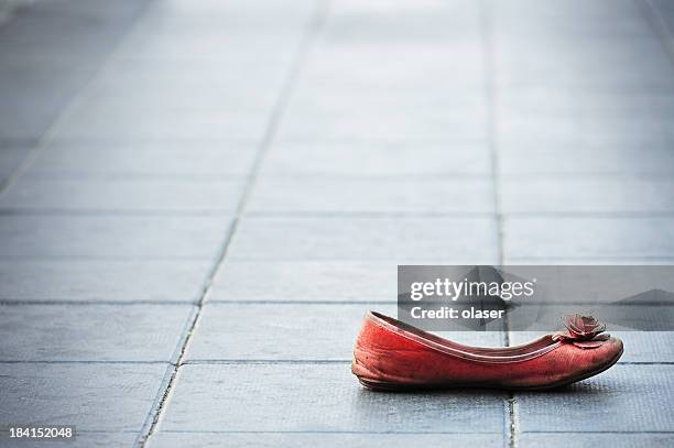 old shoe on sidewalk - red shoe stock pictures, royalty-free photos & images