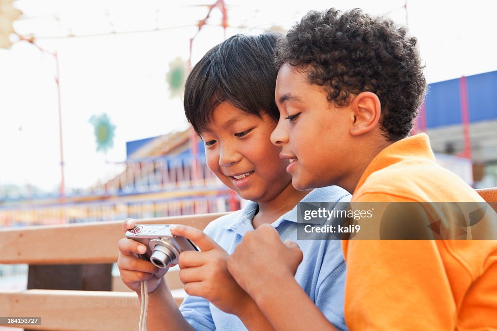 Boys playing with digital camera