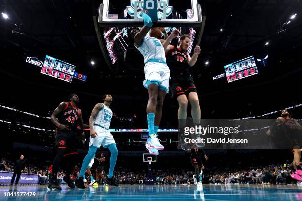 Mark Williams of the Charlotte Hornets and Jakob Poeltl of the Toronto Raptors collide in the air during the second half of an NBA game at Spectrum...