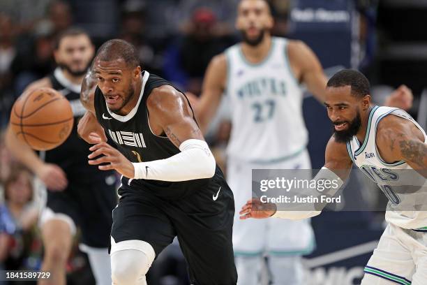 Xavier Tillman of the Memphis Grizzlies and Mike Conley of the Minnesota Timberwolves fight for the ball during the second half at FedExForum on...