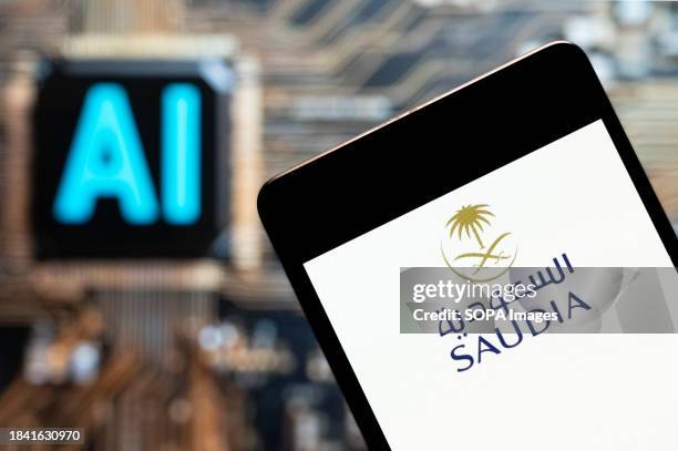 In this photo illustration, the Saudi Arabian Airlines logo seen displayed on a smartphone with an Artificial intelligence chip and symbol in the...