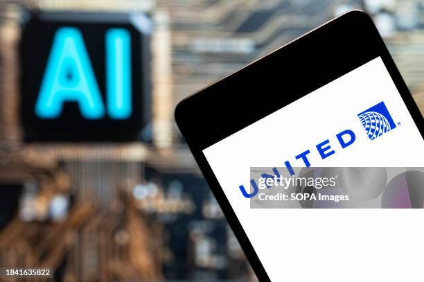 In this photo illustration, the American airline United Airlines logo seen displayed on a smartphone with an Artificial intelligence chip and symbol...