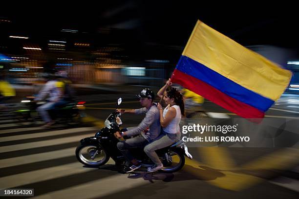 Colombian fans celebrate in Cali, Colombia on October 11 after their team qualified for the Brazil 2014 FIFA World Cup. Colombia tied 3-3 with Chile...