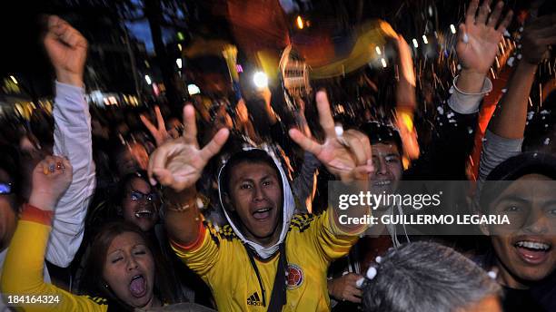 Olombian fans celebrate in Bogota on October 11 after their team qualified for the Brazil 2014 FIFA World Cup. Colombia tied 3-3 with Chile in a...