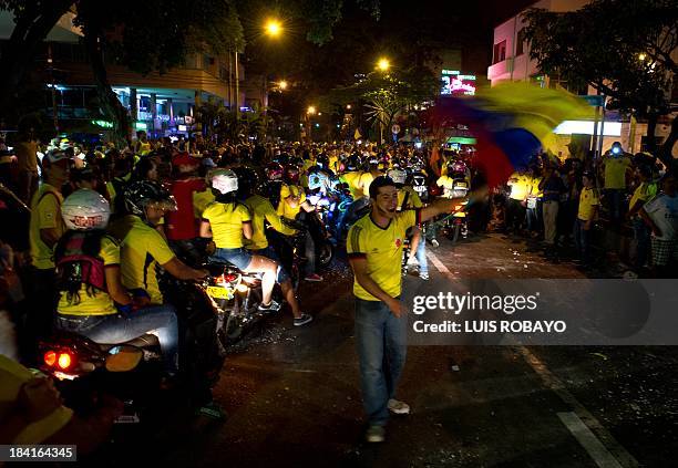 Colombian fans celebrate in Cali, Colombia on October 11 after their team qualified for the Brazil 2014 FIFA World Cup. Colombia tied 3-3 with Chile...