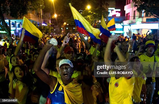 Colombian fans celebrate in Cali, Colombia on October 11 after their team qualified for the Brazil 2014 FIFA World Cup. Colombia tied 3-3 with Chile...