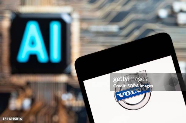 In this photo illustration, the Swedish multinational automobile manufacturer Volvo logo seen displayed on a smartphone with an Artificial...