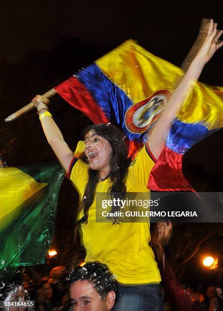Colombian fans celebrate in Bogota on October 11 after their team qualified for the Brazil 2014 FIFA World Cup. Colombia tied 3-3 with Chile in a...