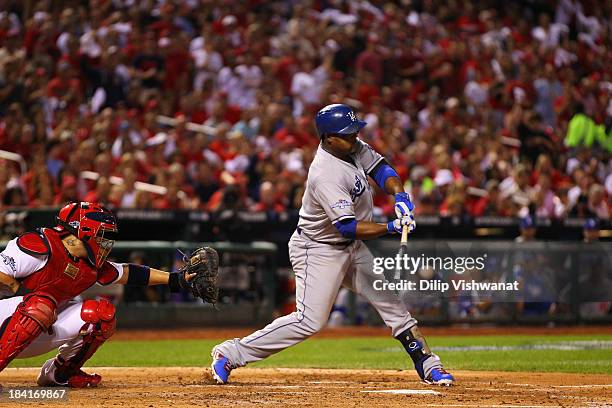 Juan Uribe of the Los Angeles Dodgers hits a two RBI single in the third inning against the St. Louis Cardinals during Game One of the National...