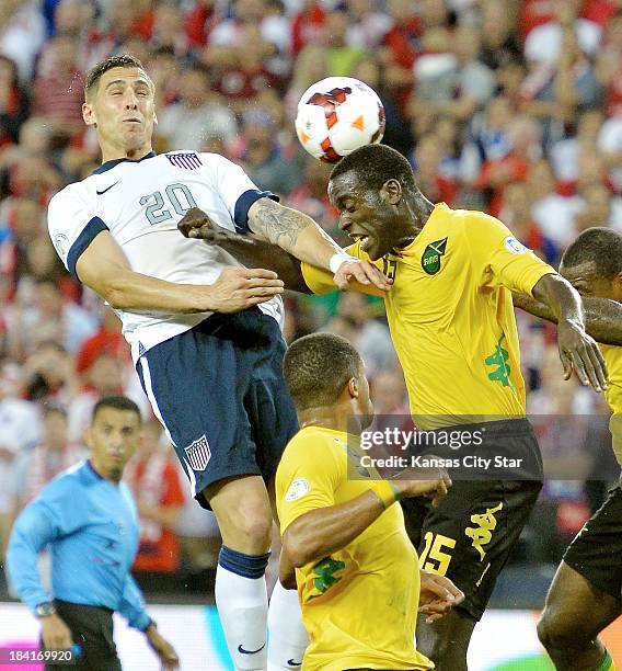 Defender Geoff Cameron and Jamaica midfielder Je-Vaughn Watson battle for the bell in front of the goal during the second half at Sporting Park in...