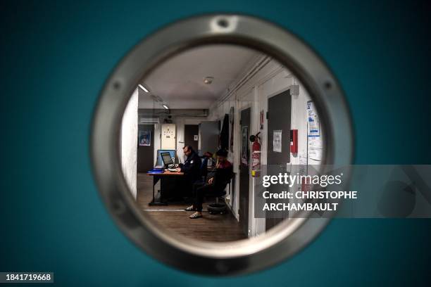 Prison warden and an inmate sit in the medical department of the Bordeaux-Gradignan jail in Gradignan on the outskirts of Bordeaux on December 11,...