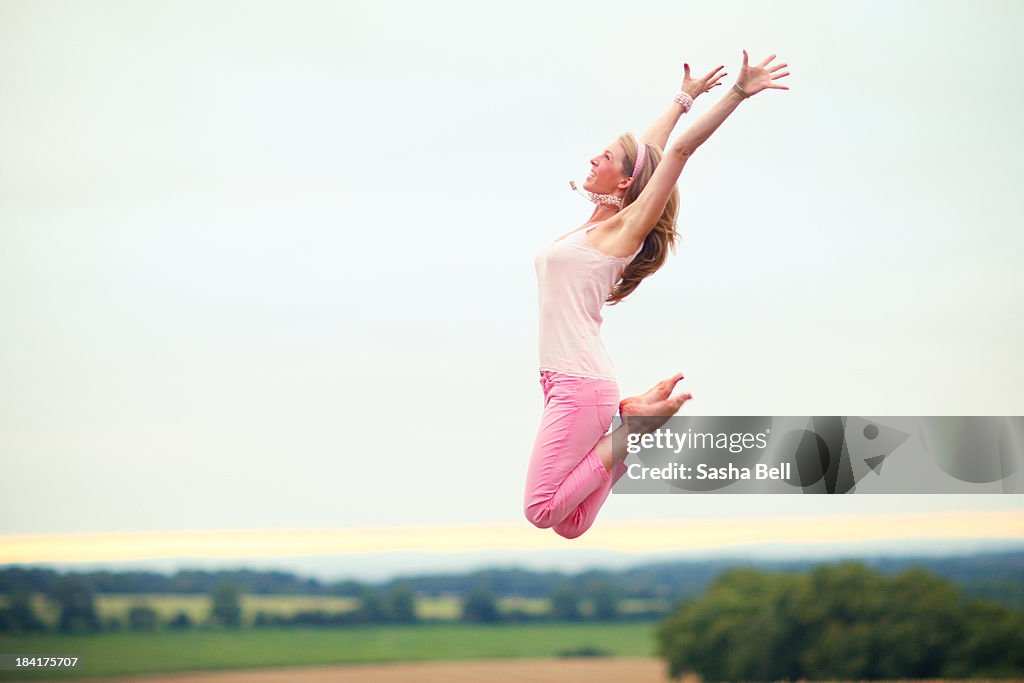 Woman Jumping in the Countryside