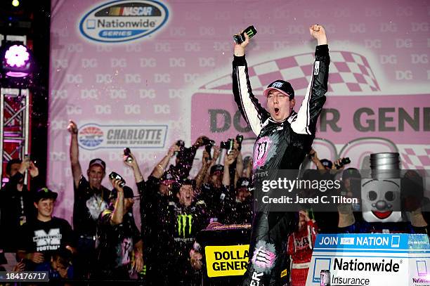 Kyle Busch, driver of the Monster Energy Toyota, celebrates in Victory Lane after winning the NASCAR Nationwide Series Dollar General 300 at...