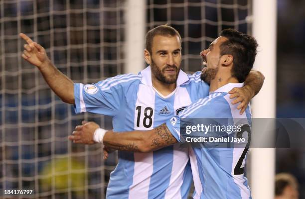 Rodrigo Palacio of Argentina celebrates with teammate Ezequiel Lavezzi after scoring during a match between Argentina and Peru as part of the 17th...